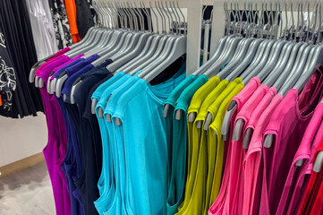 Colorful womens tank tops on a clothes rack in a department store