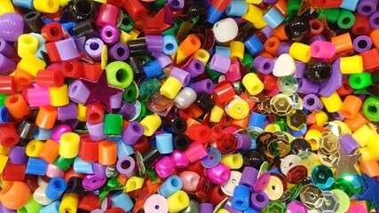 Colorful plastic beads and sequins filling frame