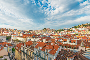 Fototapeta premium Panoramic view of Lisbon cityscape with red rooftops, historic buildings, Sao Jorge Castle and Rossio Square, Lisboa, Portugal. Old town skyline of Portuguese architecture. Travel and tourism