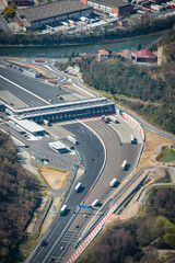 Aerial view of Biriatou showcasing a highway winding through green hills alongside the Bidassoa...