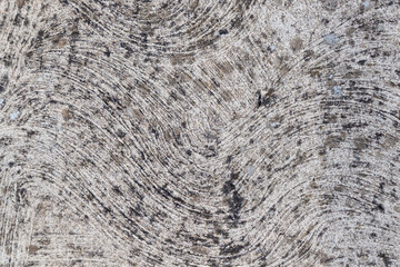 Abstract stone texture with circular patterns in gray and black
