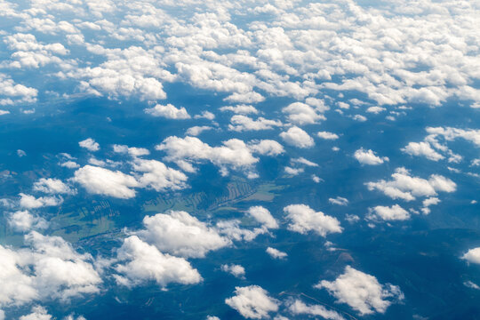 Aerial view of fluffy white clouds over landscape