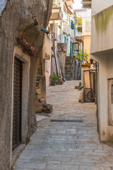 Fototapeta premium Charming stone alleyway in quaint european village with rustic architecture. Baska, Krk island, Croatia