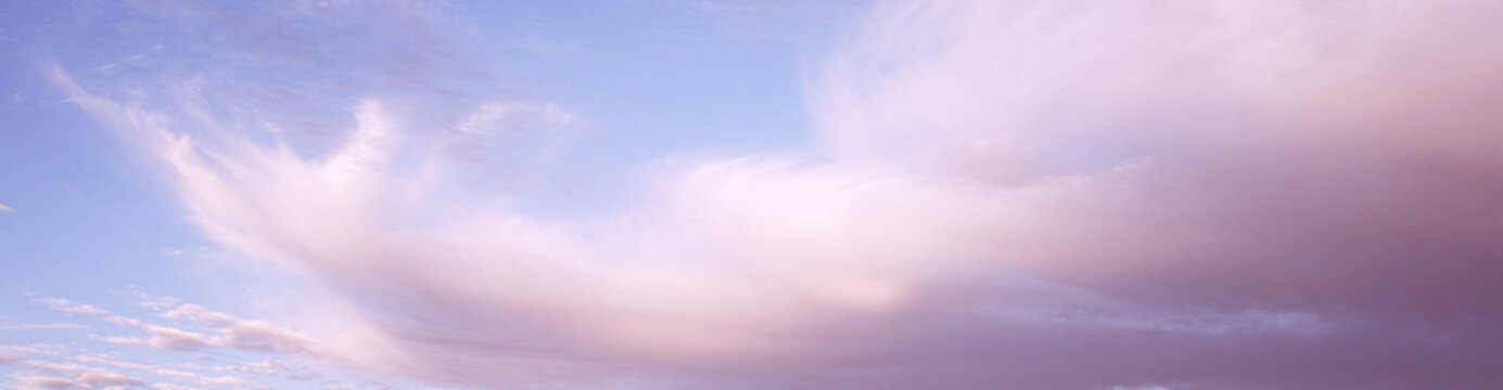 Blue purple lilac orchid pink peach white orange gold yellow cloudy evening sky background. Sunset clouds sun dawn summer. Light pale pastel soft shades. Calm twilight sleep dream fantasy. Wide banner