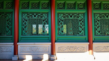Chinese style ancient building with green windows and red columns