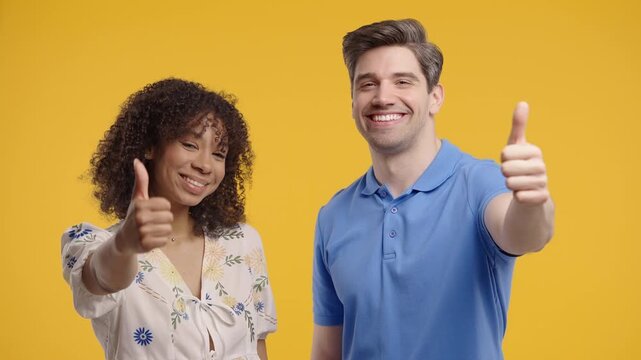 Positive Woman And Man With Hand Sign Like, Thumbs Up Gesture. Couple On Yellow 