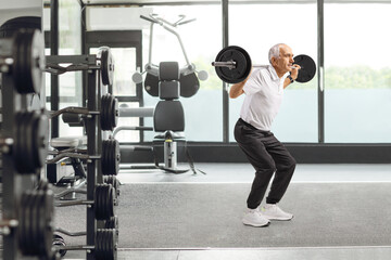 Fit senior man lifting weights