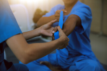 Professional physical therapist examines and cares for a young man in a physical therapy center, treating muscles and injuries of a man in a hospital.