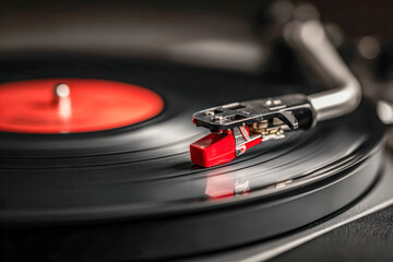 Vintage turntable needle playing a black vinyl record with a red label, capturing the nostalgic charm of analog music in a cozy setting