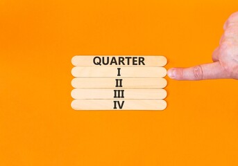 1st first quarter 1 symbol. Concept word Quarter 1 on beautiful wooden sticks. Beautiful orange background. Businessman's hand. Business, happy 1st first quarter 1 Q1 concept. Copy space.