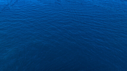 Aerial view of the deep blue sea surface. Ideal for backgrounds, textures and patterns.