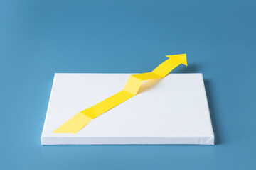 One yellow arrow symbol breaking out from a plain white canvas. Blue background.