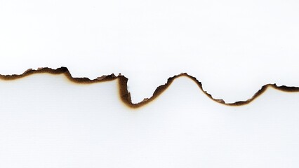 A piece of white paper with scorched and burned edges. Fire damaged paper border background texture. Burned paper texture pattern isolated on white background.