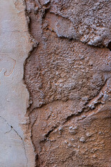 Cracked Concrete Wall with Exposed Old Brick