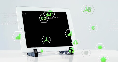Displaying white tablet computer resting on stand at studio table, with floating green hex icons