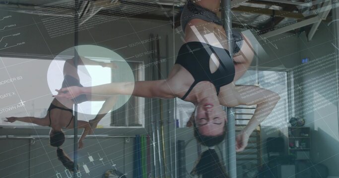 Balancing chrome pole fitness woman holding inverted hold in studio, with mirrored wall, props - Powered by Adobe