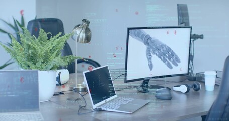 Showing desktop monitor featuring robotic prosthetic hand in office, with laptops, copy space