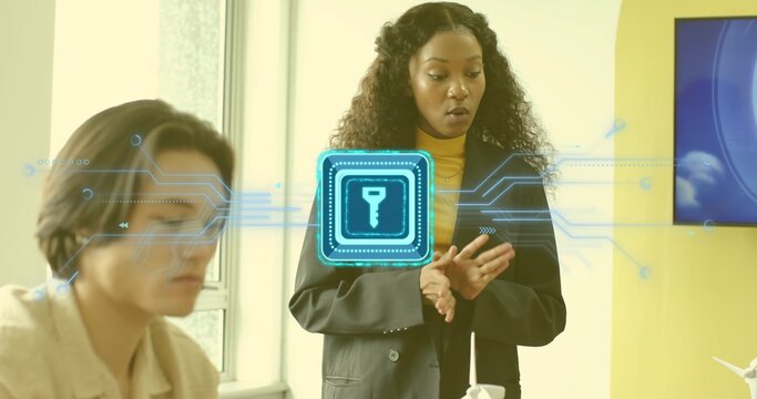 Presenting businesswoman in black blazer explaining encryption in office, with holographic key icon - Powered by Adobe