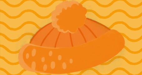 Displaying orange beanie hat with ribbed stitching and dotted cuff accents on yellow-orange pattern