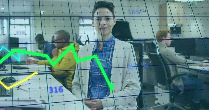 Analyzing professional wearing cardigan tracking graph overlays in open-plan office with monitors