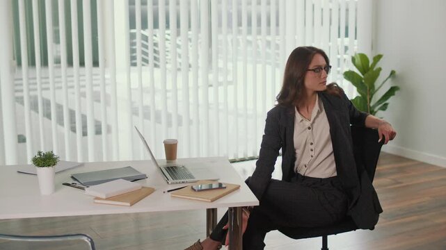 Employee Wellbeing and Healthy Office. Office Manager Practices Seated Spinal Twist for Thoracic and Lumbar Spine to Relieve Tension, Improve Flexibility, Support Posture and Create a Balanced