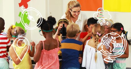 Helping teacher wearing goggles guiding students examining microscope in lab corner, with pipettes