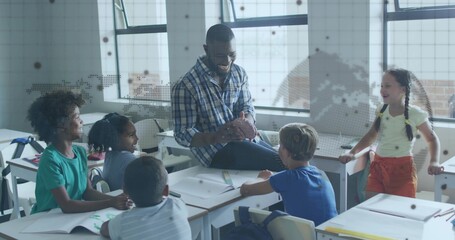 Guiding teacher in plaid shirt directing student discussion in classroom, with notebooks, backpacks