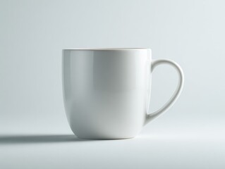 Fototapeta premium Close Up of a Glossy White Ceramic Mug with Smooth Curves Set on a Pale Gray Studio Backdrop