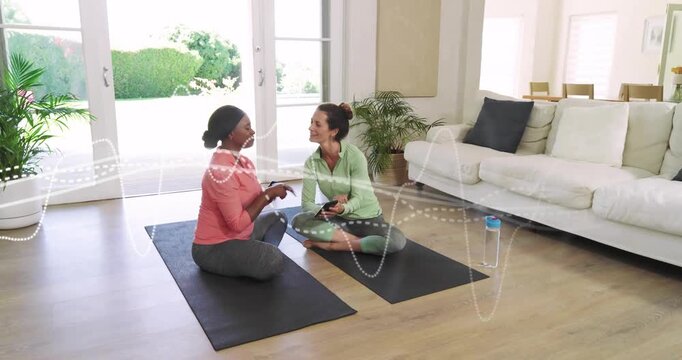 Guide tapping tablet starting home fitness routine and participant mirroring clap with sound wave