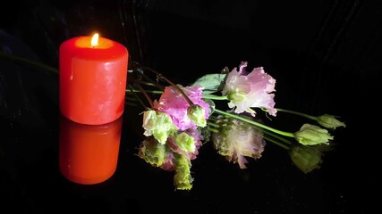Bouquet of flowers and red candles burning on black background. Mourning, condolence and sorrow concept