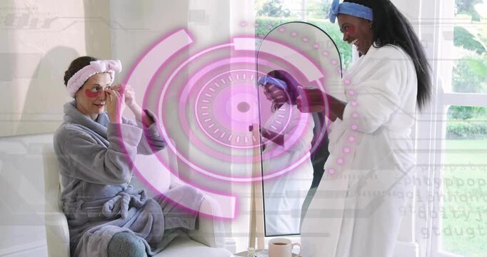 Standing assistant scooping gel patch and guiding friend applying under-eye patches for skincare