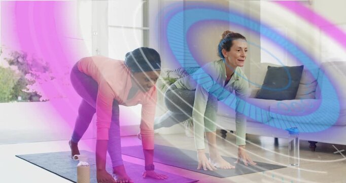Women tapping phone starting animated fitness timer stepping on mats for low lunges for hip stretch