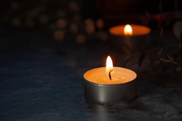 Two glowing candles with soft light and delicate flowers, evoking feelings of remembrance and peace for All Saints’ Day or All Souls’ Day. A warm and respectful image for memorial and spiritual themes