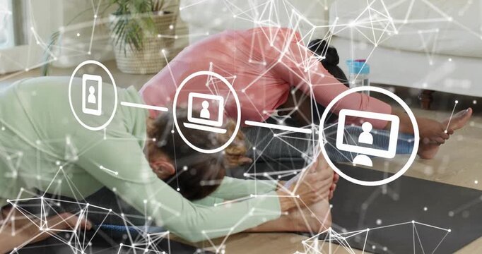 women sitting on yoga mats then starting hamstring stretch before switching into twist for fitness