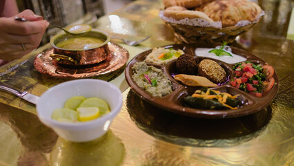 Traditional Egyptian meal with hummus, falafel, and fresh salad served with pita bread during a relaxing vacation.

