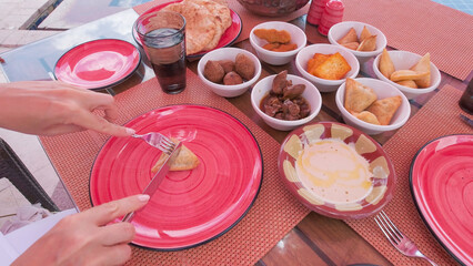 Traditional Egyptian meal served outdoors during a vacation, featuring a variety of local dishes and vibrant tableware.