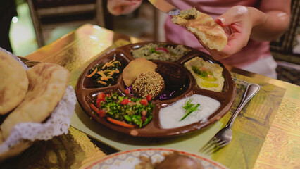 Traditional Egyptian meal with soup, falafel, and assorted dips served with bread during a relaxing vacation.