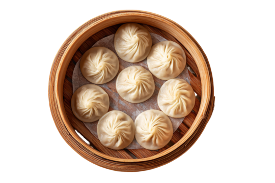 Steaming hot soup dumplings in a bamboo steamer basket overhead view