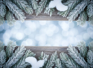 Frosted Evergreen Branches Border on Rustic Wood