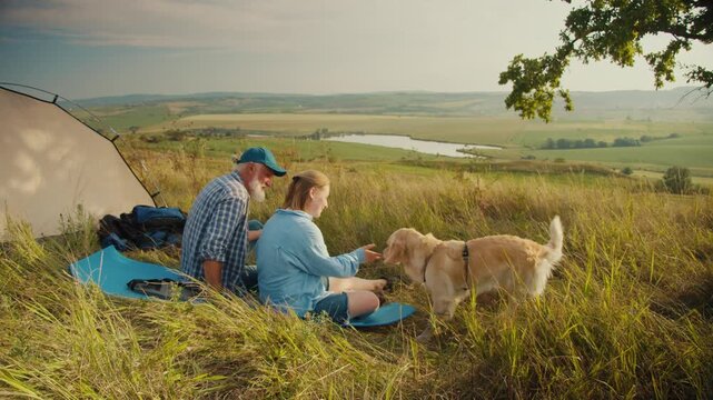 Nature-Centered Living With Pets. Senior Man Sits by Tent With His Family and Dog, Admiring the Beautiful Landscape. A Calm Escape Into Nature for Connection, Healing, and Emotional Balance