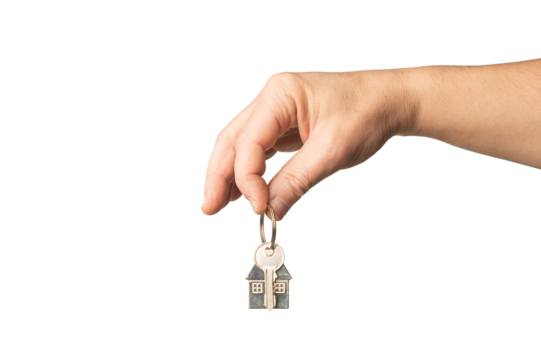 Hand holding a house-shaped key, concept of home purchase or real estate investment