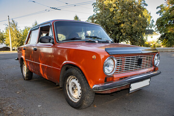 Old red car parked on the street — vintage vehicle.