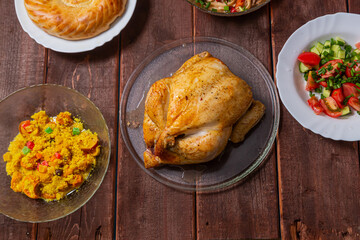 Couscous with dried hands and turmeric, grilled whole chicken, flatbread