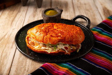 Pambazo. Mexican sandwich marinated in red sauce and roasted on a comal traditionally stuffed with...
