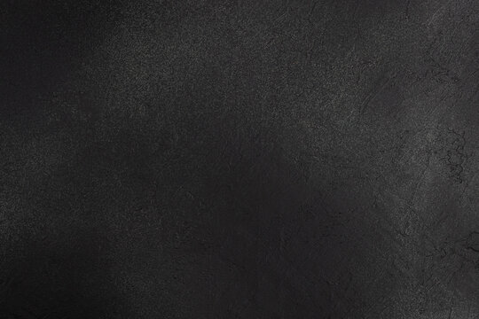 Dark textured background for food photography and culinary compositions, minimalist black stone surface with copy space for text
