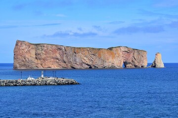 Fototapeta premium Le Rocher Perce, famous rock in Gaspesie, Quebec, Canada with a beautiful blue sky