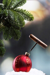 Corkscrew and Christmas red ball to decorate Christmas tree. Concept of the beginning of New Year holiday. Copy space.