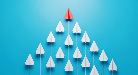 Red paper airplane leads white airplanes in formation against blue background