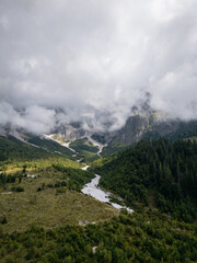 Aerial view of misty Austrian Alps mountain valley with river