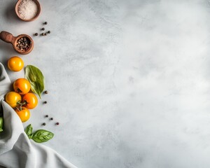 Yellow tomatoes with basil, salt, and pepper on a light gray background. Minimal and natural food composition with soft light and copy space for healthy cooking or design projects.